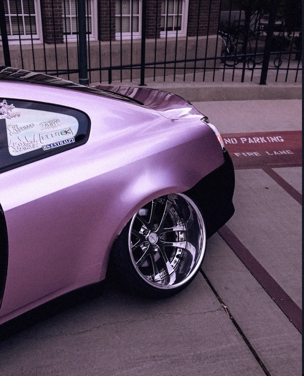 Pink Infiniti's rear wheel and fender