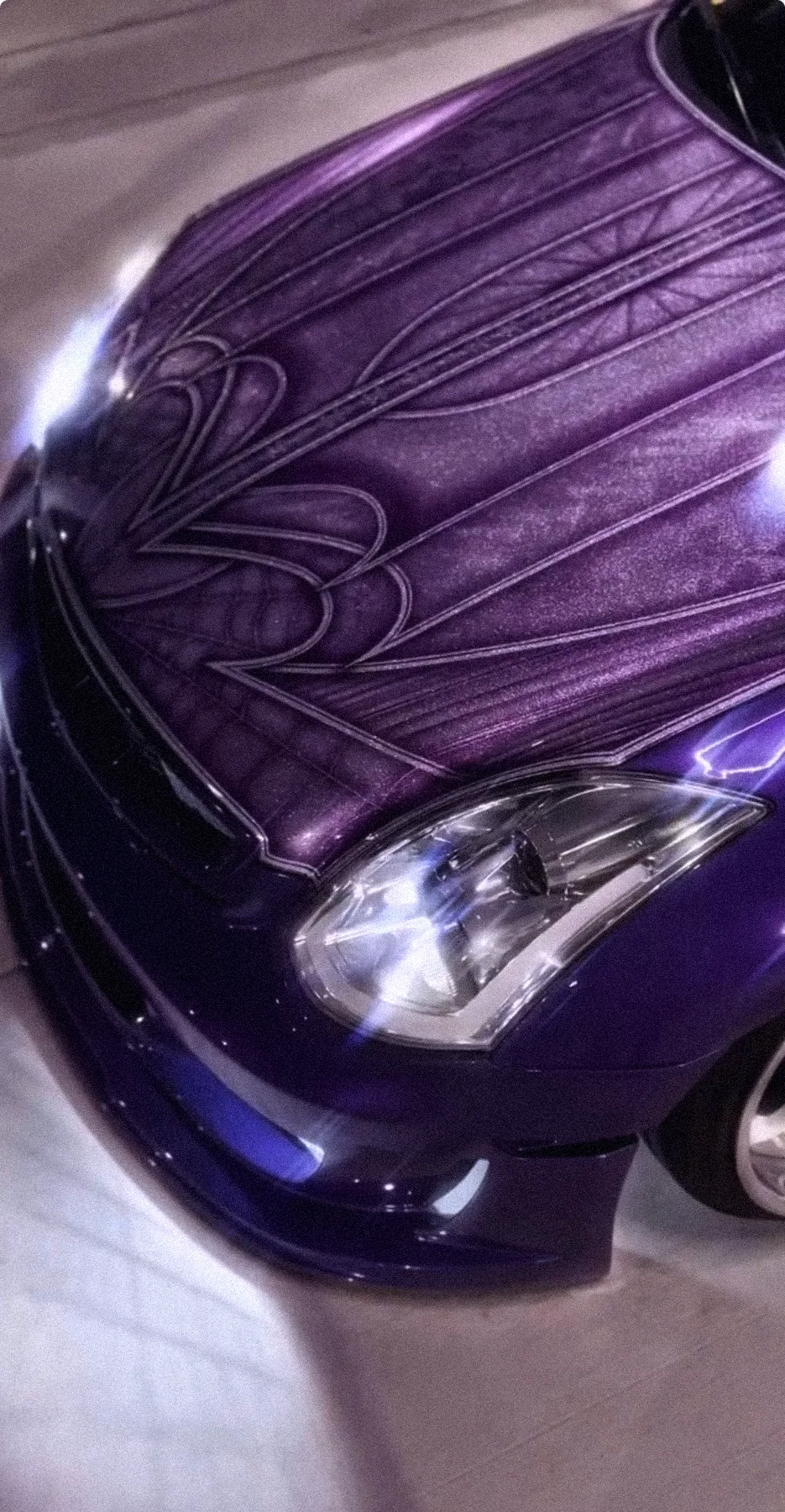 Close-up of the purple Infiniti's pinstriped hood
