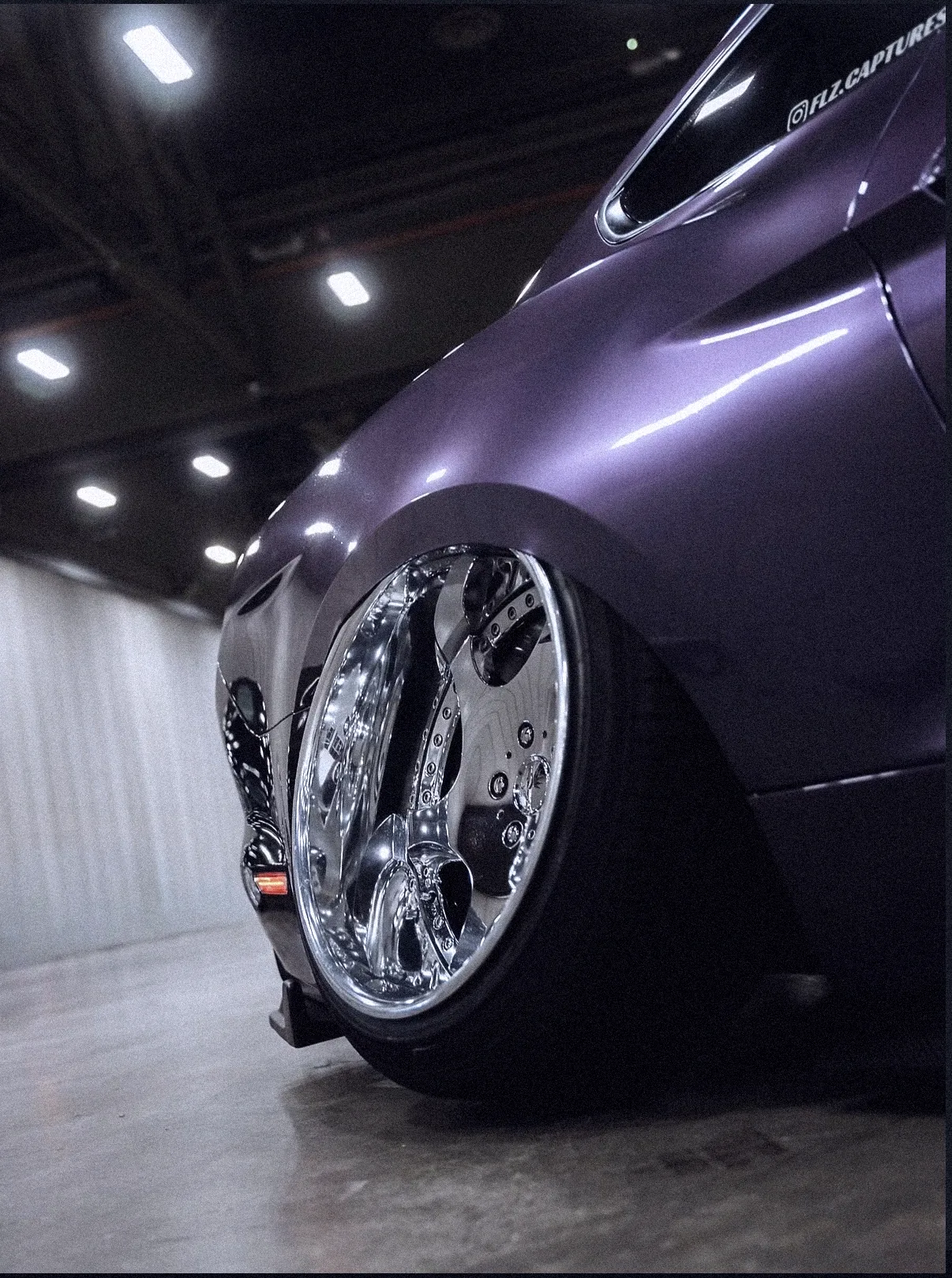 Low angle of the purple Mustang's chrome wheel