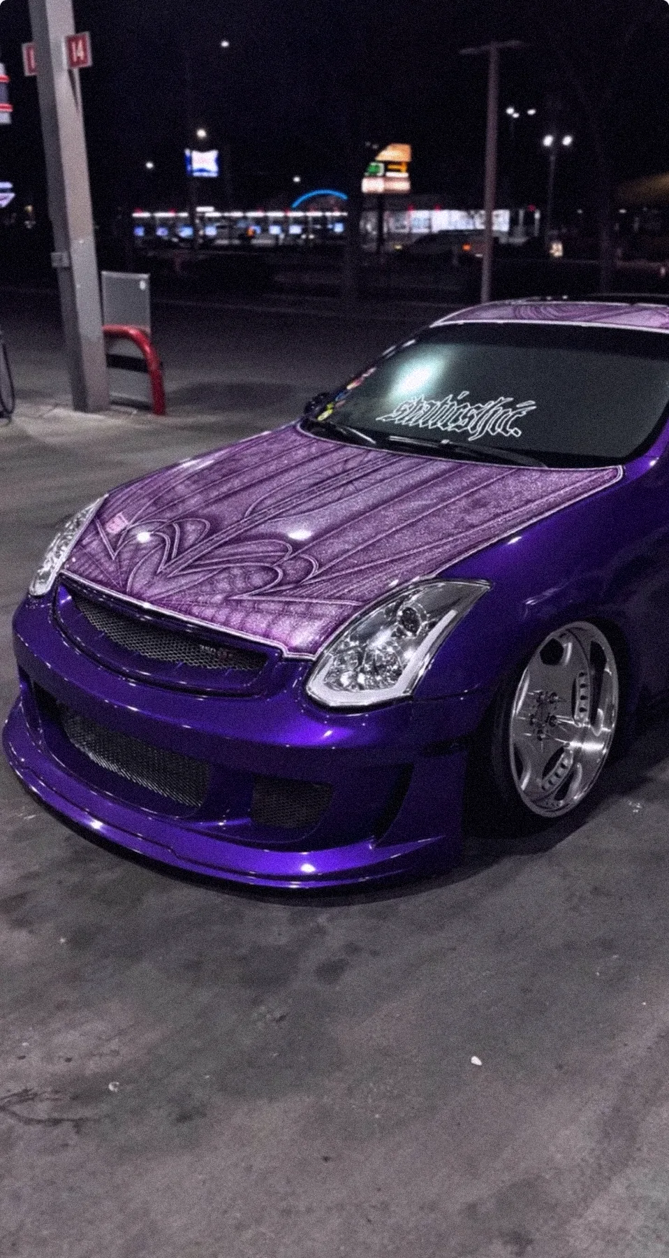 Purple Infiniti coupe with a pinstriped hood